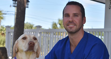 tech-with-dog-outside Pet Dental Care in Brevard County: Vet Hugs Dog