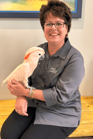 Bobbi Hardymon Female with short brown hair and glasses holding a large bird on wrist