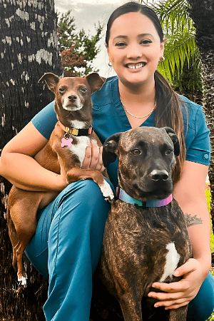 Mailynn Female with long brown hair posing with small brown dog and large brindled colored dog